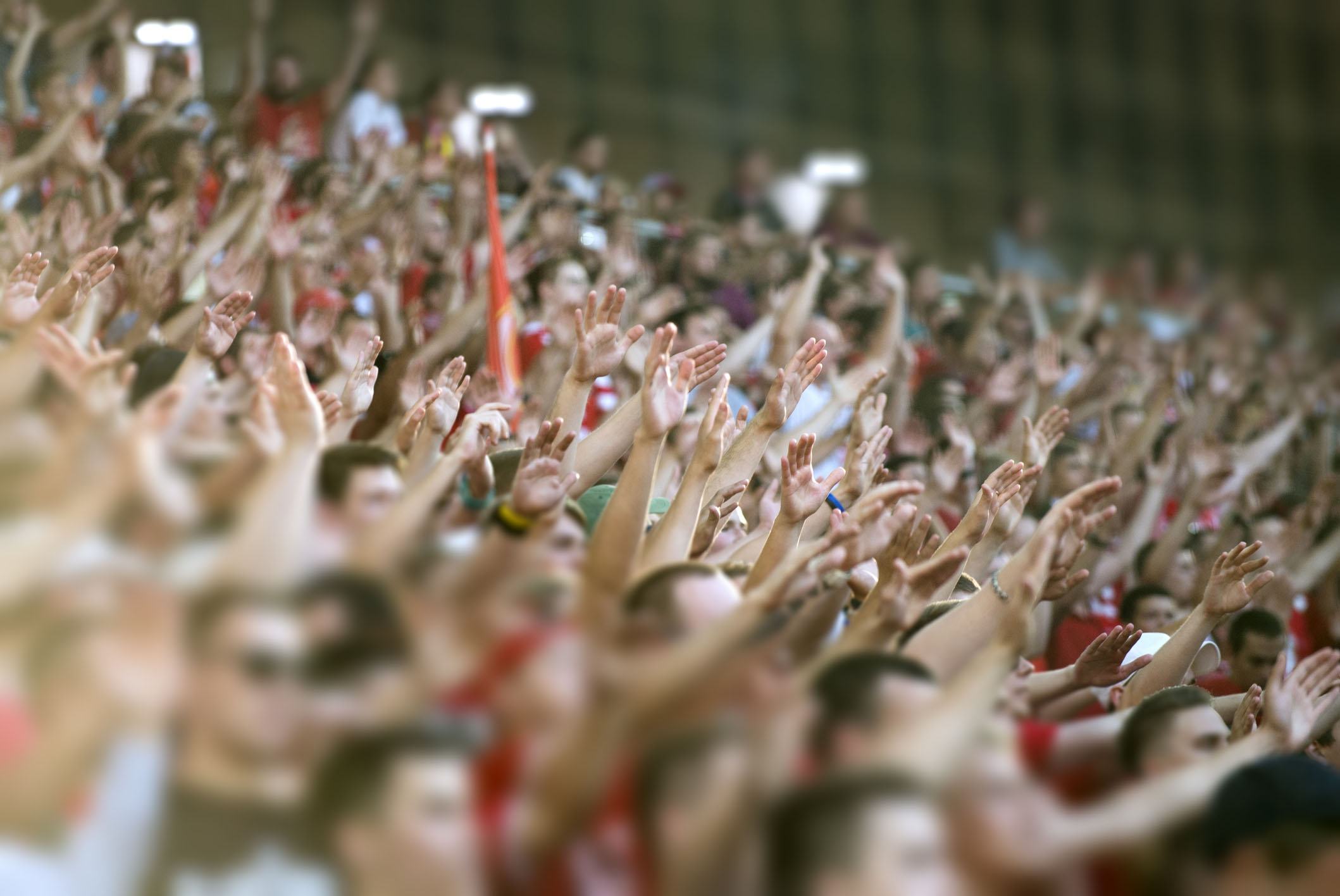 SMU fans with hands raised in the stands